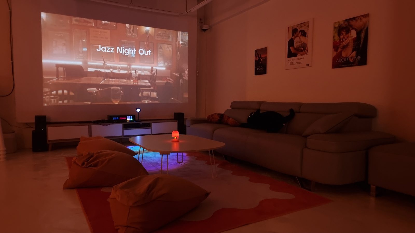 The screening room &mdash; a projector wall, sofa, floor cushions and a karaoke machine.
